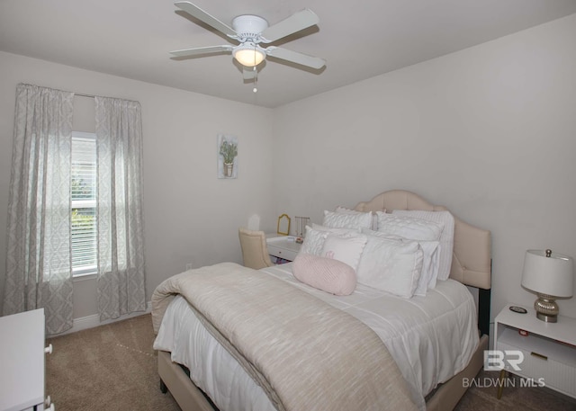 carpeted bedroom featuring baseboards and ceiling fan