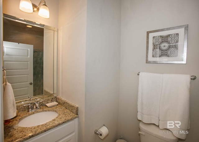 bathroom featuring toilet and vanity