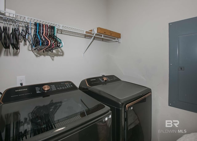 laundry room featuring separate washer and dryer, electric panel, and laundry area