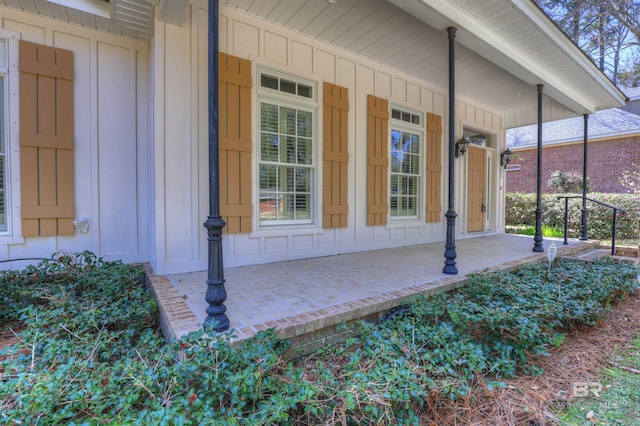 entrance to property with a porch and board and batten siding