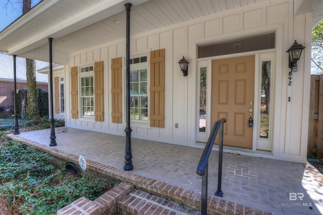 property entrance featuring a porch and board and batten siding