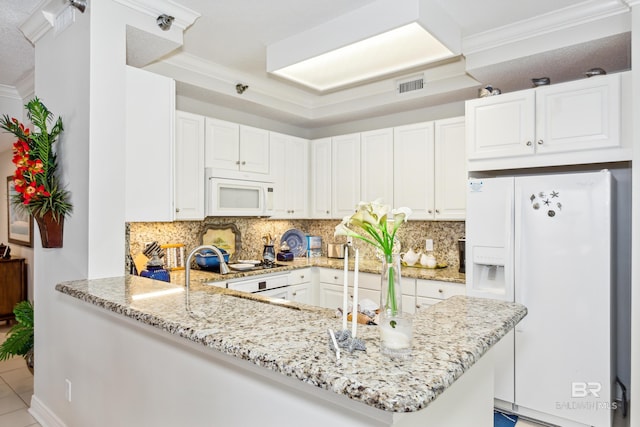 kitchen with white appliances, visible vents, white cabinets, light stone countertops, and crown molding