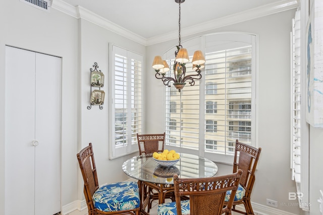 dining area with a wealth of natural light, visible vents, crown molding, and an inviting chandelier