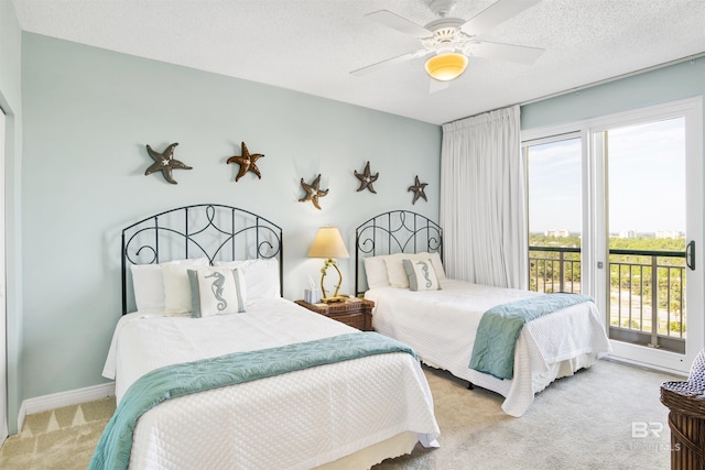 carpeted bedroom with access to outside, baseboards, ceiling fan, and a textured ceiling