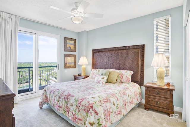 carpeted bedroom featuring a textured ceiling, baseboards, a ceiling fan, and access to exterior