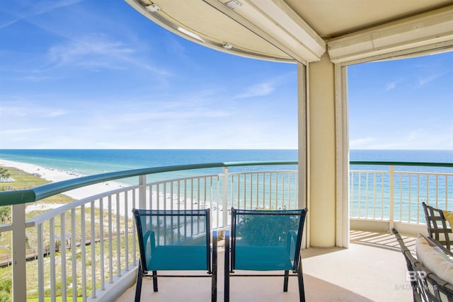 balcony featuring a beach view and a water view