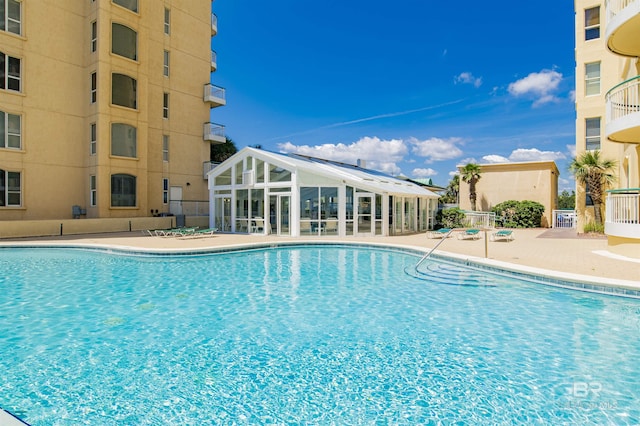 pool featuring a patio and fence