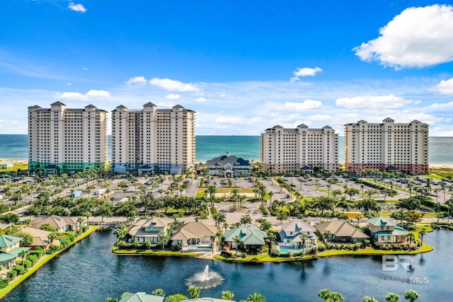 birds eye view of property with a water view and a city view