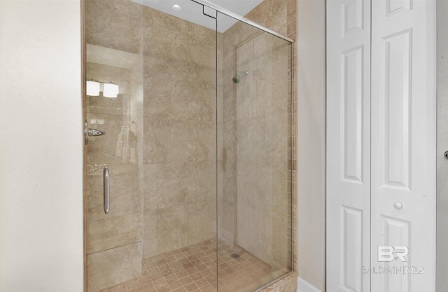 full bath featuring a shower stall and a closet