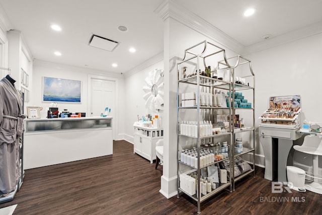 interior space featuring recessed lighting, wood finished floors, baseboards, and ornamental molding