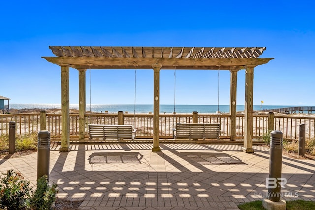 view of patio / terrace featuring a pergola and a water view