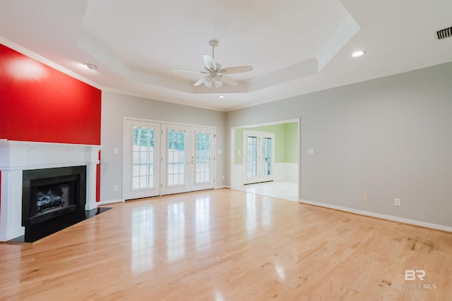 19711 Hunters Loop, Fairhope, AL 36532 - unfurnished living room featuring ceiling fan, a tray ceiling, ornamental molding, wood finished floors, and baseboards