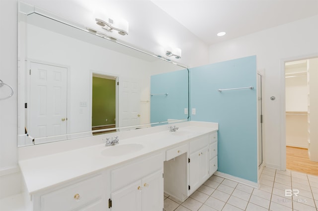 19711 Hunters Loop, Fairhope, AL 36532 - full bath featuring double vanity, tile patterned flooring, a shower stall, a spacious closet, and baseboards