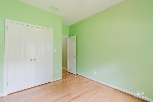19711 Hunters Loop, Fairhope, AL 36532 - unfurnished bedroom with light wood-style flooring, a closet, and baseboards