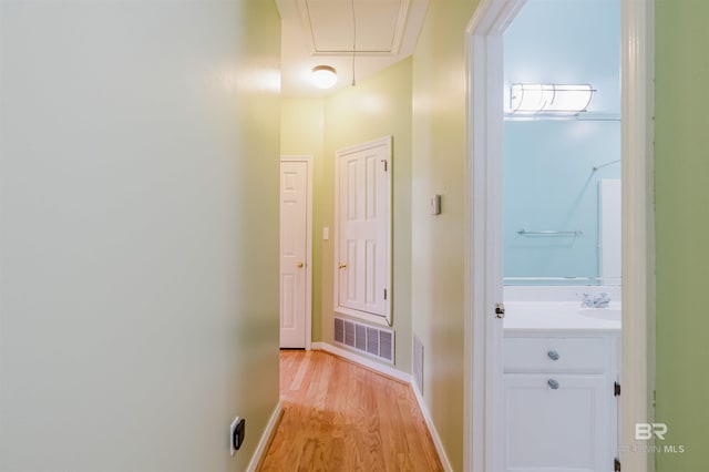 19711 Hunters Loop, Fairhope, AL 36532 - hallway with attic access, light wood finished floors, baseboards, and a sink