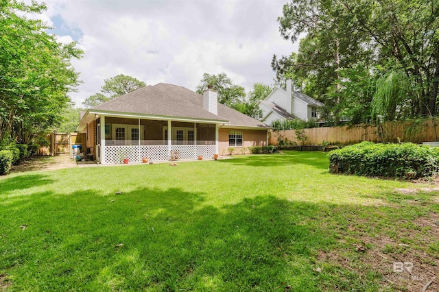 19711 Hunters Loop, Fairhope, AL 36532 - rear view of house with a sunroom, roof with shingles, and a chimney