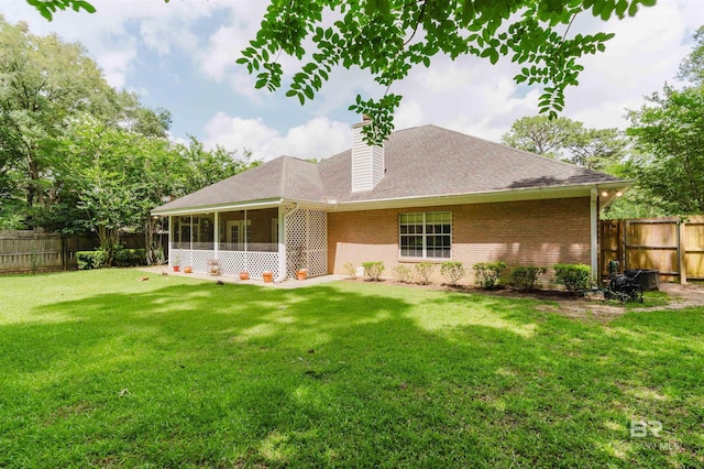 19711 Hunters Loop, Fairhope, AL 36532 - rear view of property featuring a sunroom, brick siding, a shingled roof, and a chimney