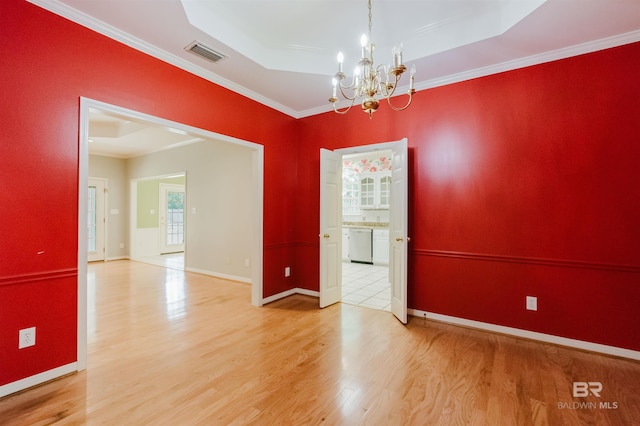 19711 Hunters Loop, Fairhope, AL 36532 - empty room featuring wood finished floors, a chandelier, a tray ceiling, crown molding, and baseboards
