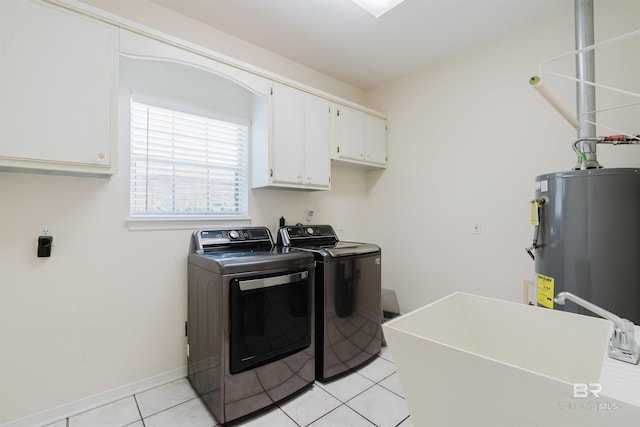 19711 Hunters Loop, Fairhope, AL 36532 - washroom featuring washing machine and clothes dryer, cabinet space, gas water heater, light tile patterned flooring, and baseboards
