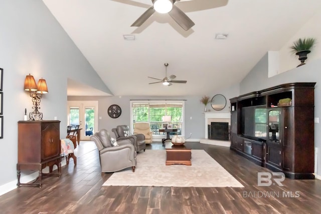 living area featuring ceiling fan, visible vents, dark wood-style floors, baseboards, and high vaulted ceiling