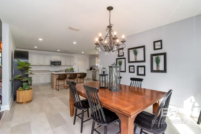 dining space featuring light floors, a chandelier, recessed lighting, and visible vents