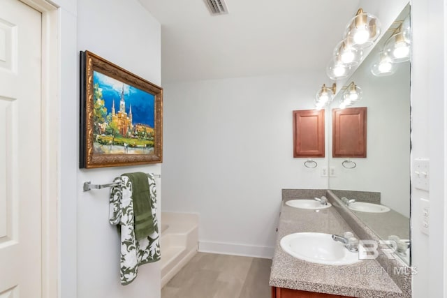 full bathroom with double vanity, a sink, baseboards, and visible vents