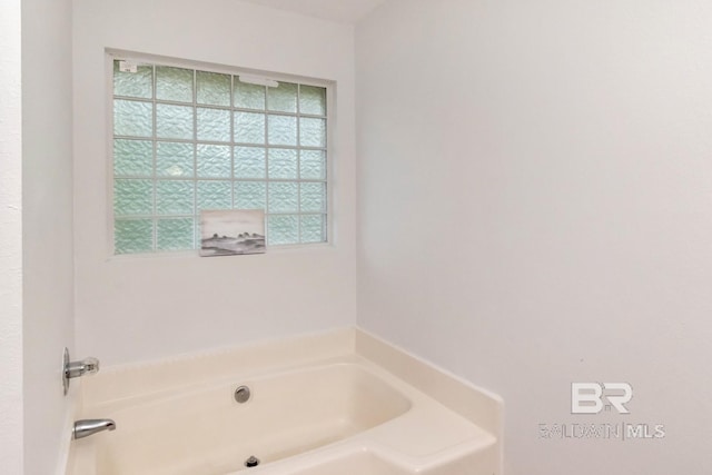 full bath with a wealth of natural light and a garden tub