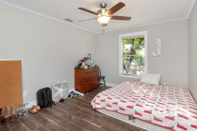 bedroom with wood tiled floor, visible vents, and ceiling fan