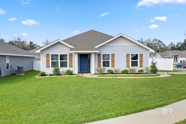 single story home with a front yard and central AC