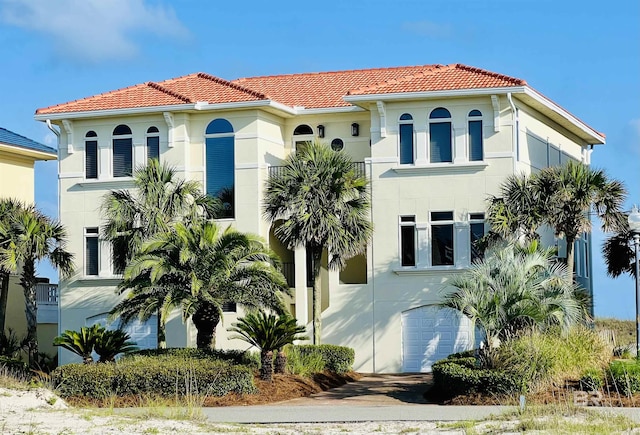 mediterranean / spanish home featuring a garage