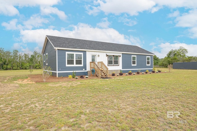 manufactured / mobile home featuring a front lawn