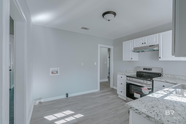 kitchen featuring stainless steel range with electric stovetop, light stone counters, light hardwood / wood-style floors, and white cabinets