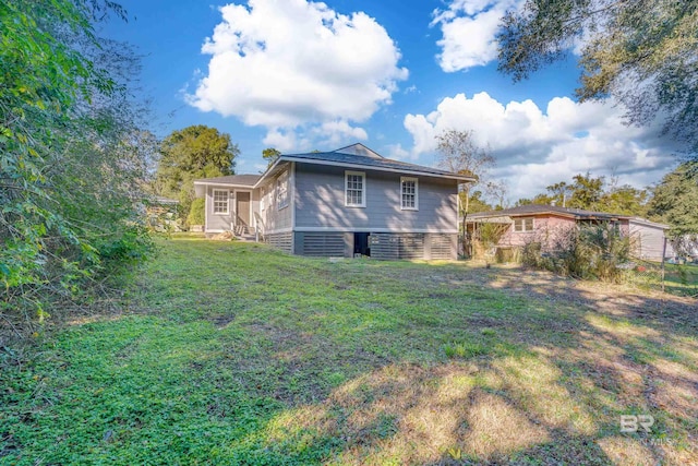 back of property featuring a yard