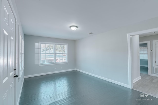 unfurnished bedroom featuring dark hardwood / wood-style floors and a closet