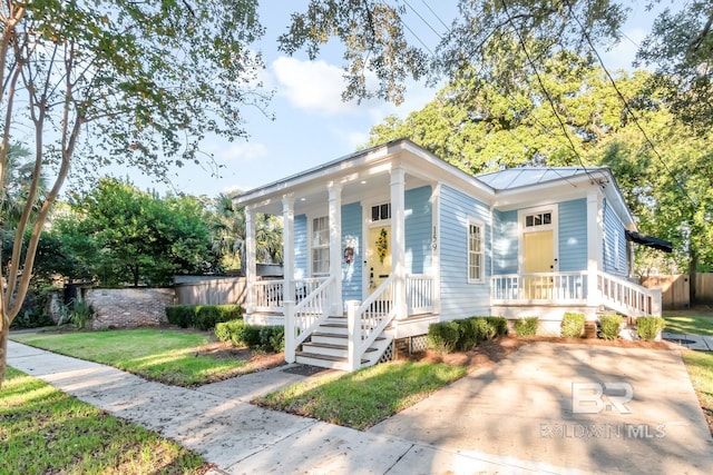 view of front of home with covered porch and a front yard