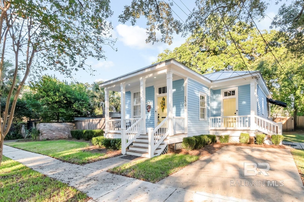 159 S Dearborn St, Mobile, AL 36602 - shotgun-style home featuring a porch