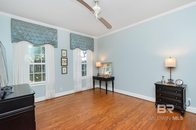 living area featuring ceiling fan, crown molding, and hardwood / wood-style flooring