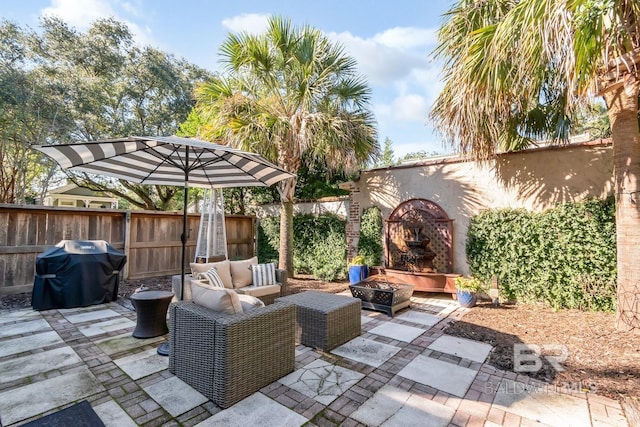 view of patio / terrace featuring grilling area and an outdoor living space with a fire pit