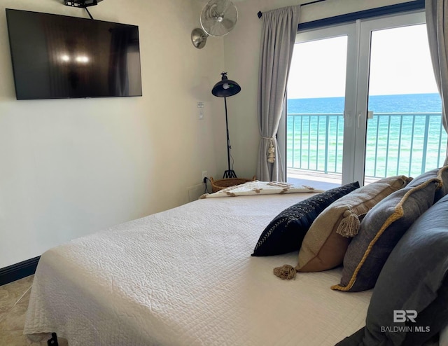 bedroom featuring access to exterior and a water view