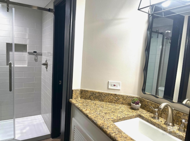 bathroom featuring a shower stall and vanity