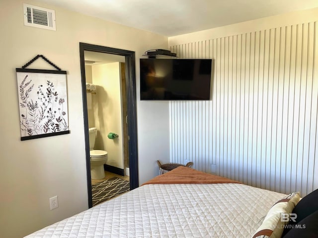 bedroom with visible vents and ensuite bathroom