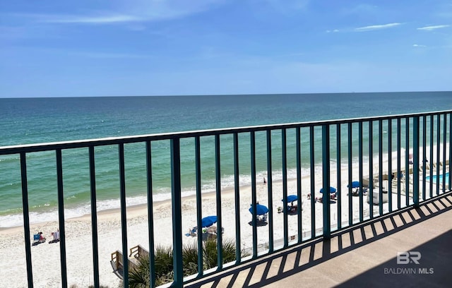 balcony with a beach view and a water view