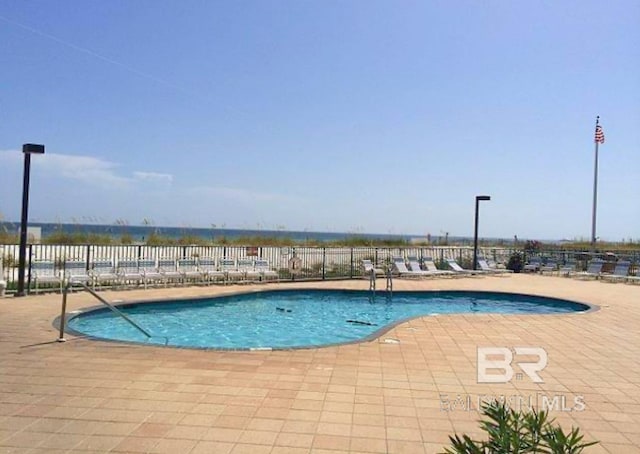 pool featuring a patio area and fence