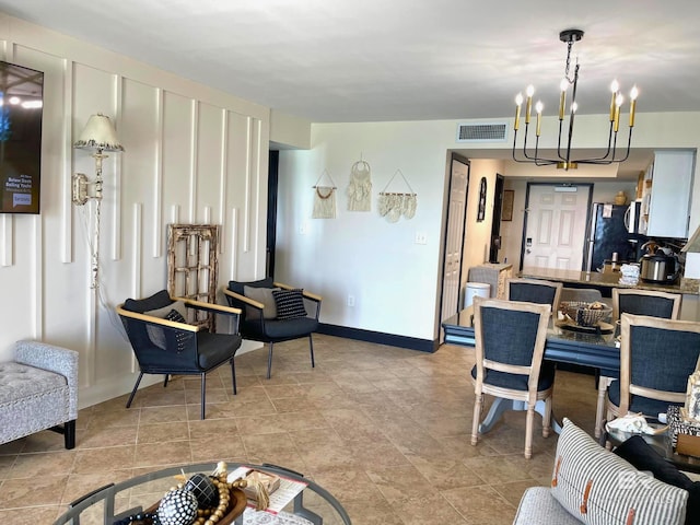 interior space with a chandelier, visible vents, and baseboards