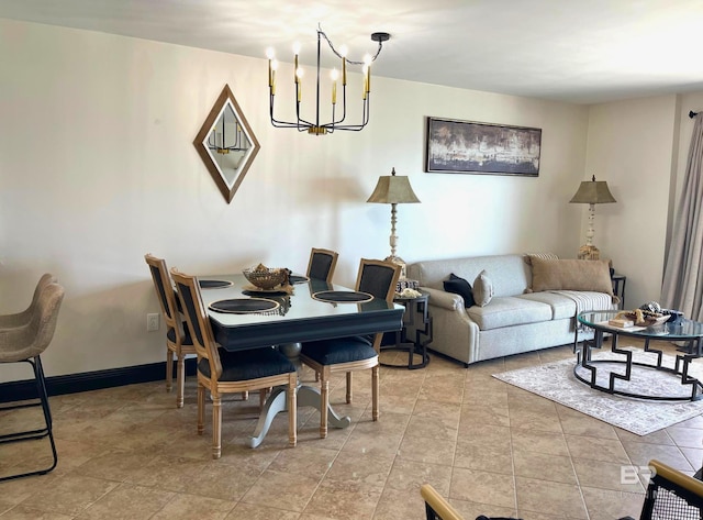 dining room with an inviting chandelier and baseboards