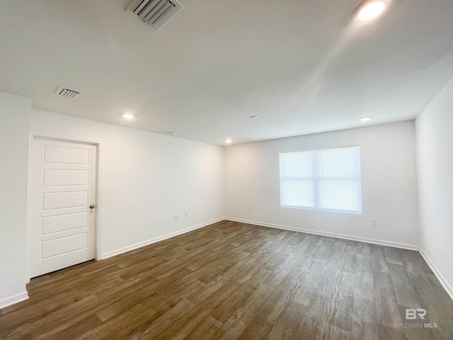 empty room featuring dark hardwood / wood-style flooring