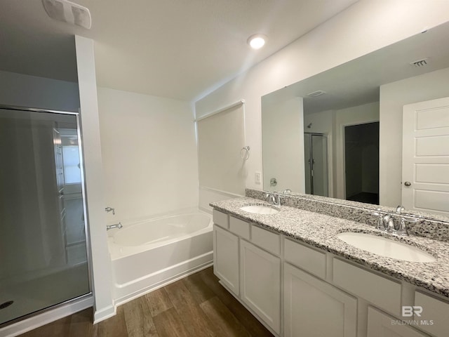 bathroom featuring hardwood / wood-style floors, vanity, and separate shower and tub