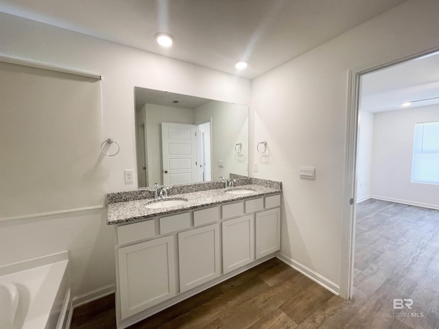 bathroom featuring vanity and hardwood / wood-style flooring