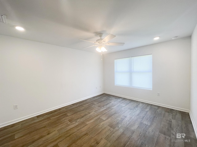 empty room featuring ceiling fan and dark hardwood / wood-style flooring