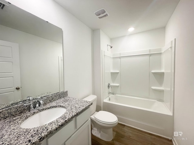 full bathroom with bathing tub / shower combination, vanity, wood-type flooring, and toilet